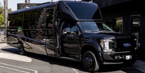 Front three-quarter view of the executive shuttle bus (California plate visible)