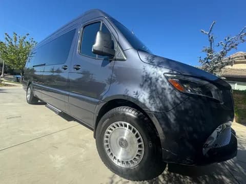 Gray executive van, front three-quarter view