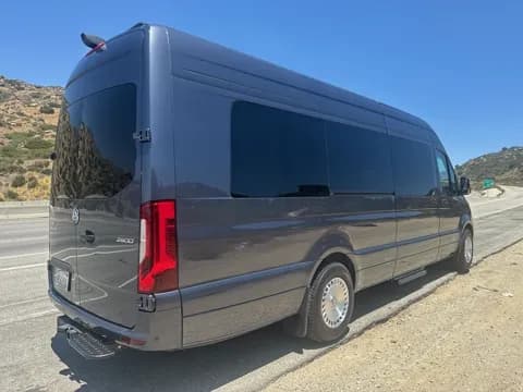 Rear three-quarter view of the tinted-window executive van
