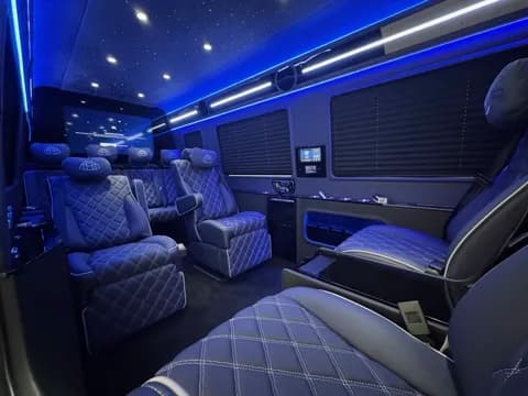 Rear lounge seating in blue ambient light, alternate angle