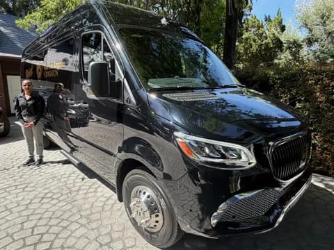 Guests posing alongside the executive van