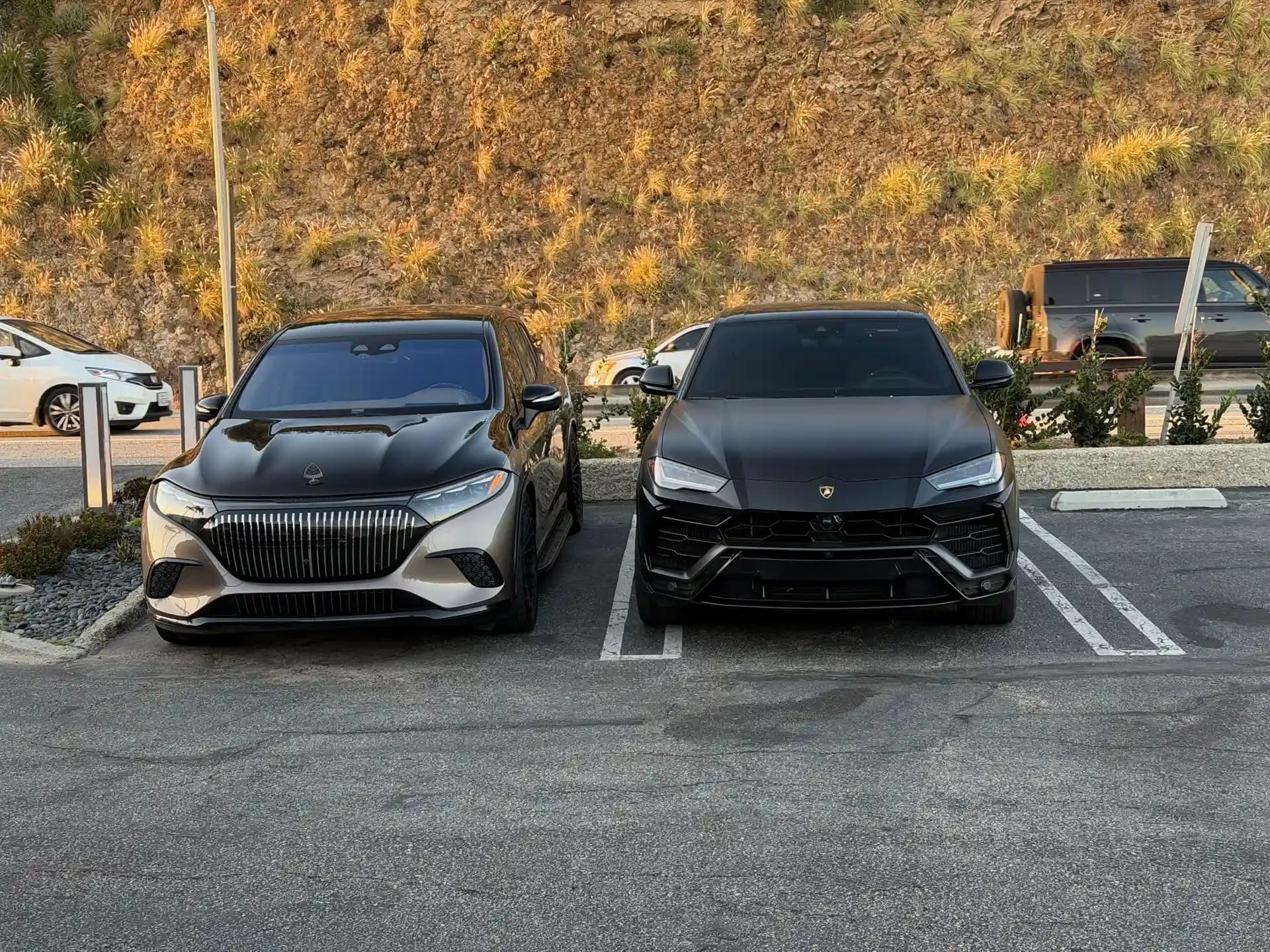Maybach EQS SUV parked beside a Lamborghini Urus